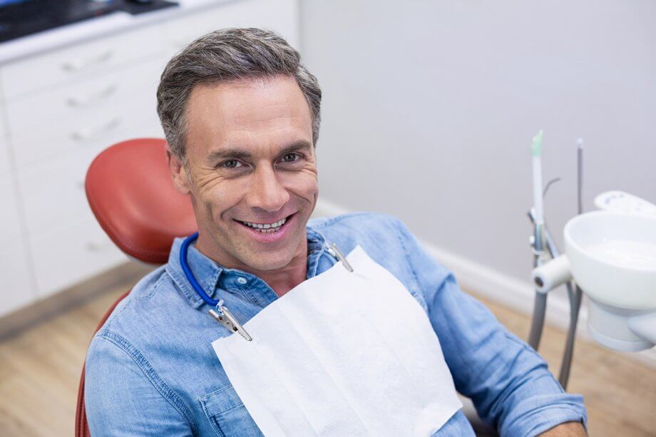 male patient smiling from dental chair