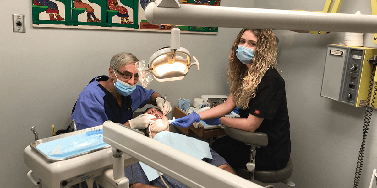 Dentists at Bella Dental Preforming Periodontal Procedure